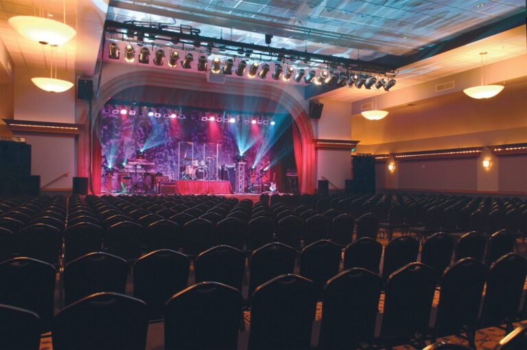 The Pacific Showroom set for an event, with stage lighting above rows of seating