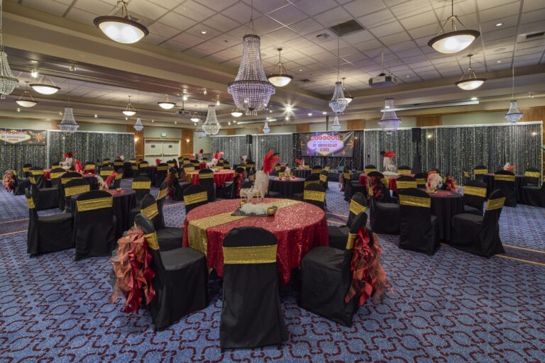 The ballroom under its crystal chandeliers, set for dinner